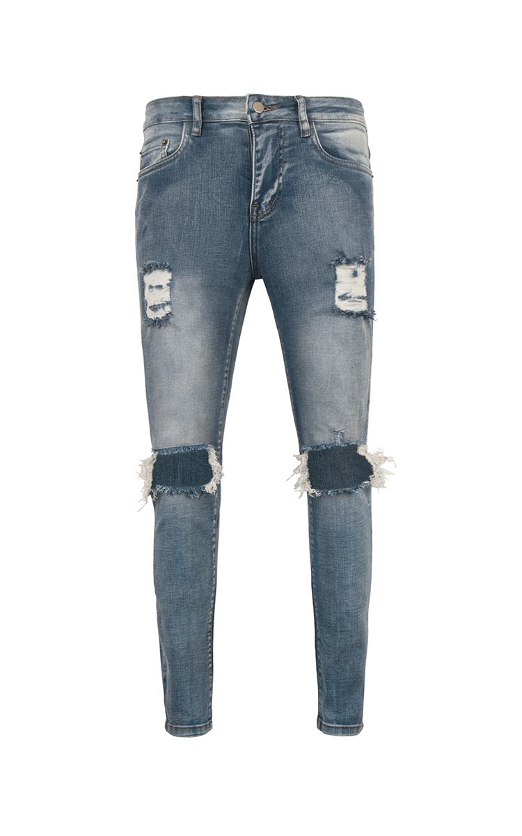 Distressed Skinny Jeans In Mid Wash