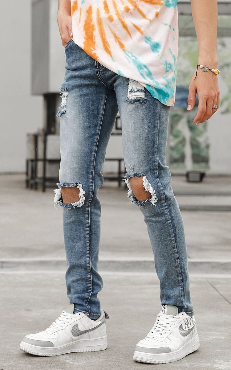 Distressed Skinny Jeans In Mid Wash