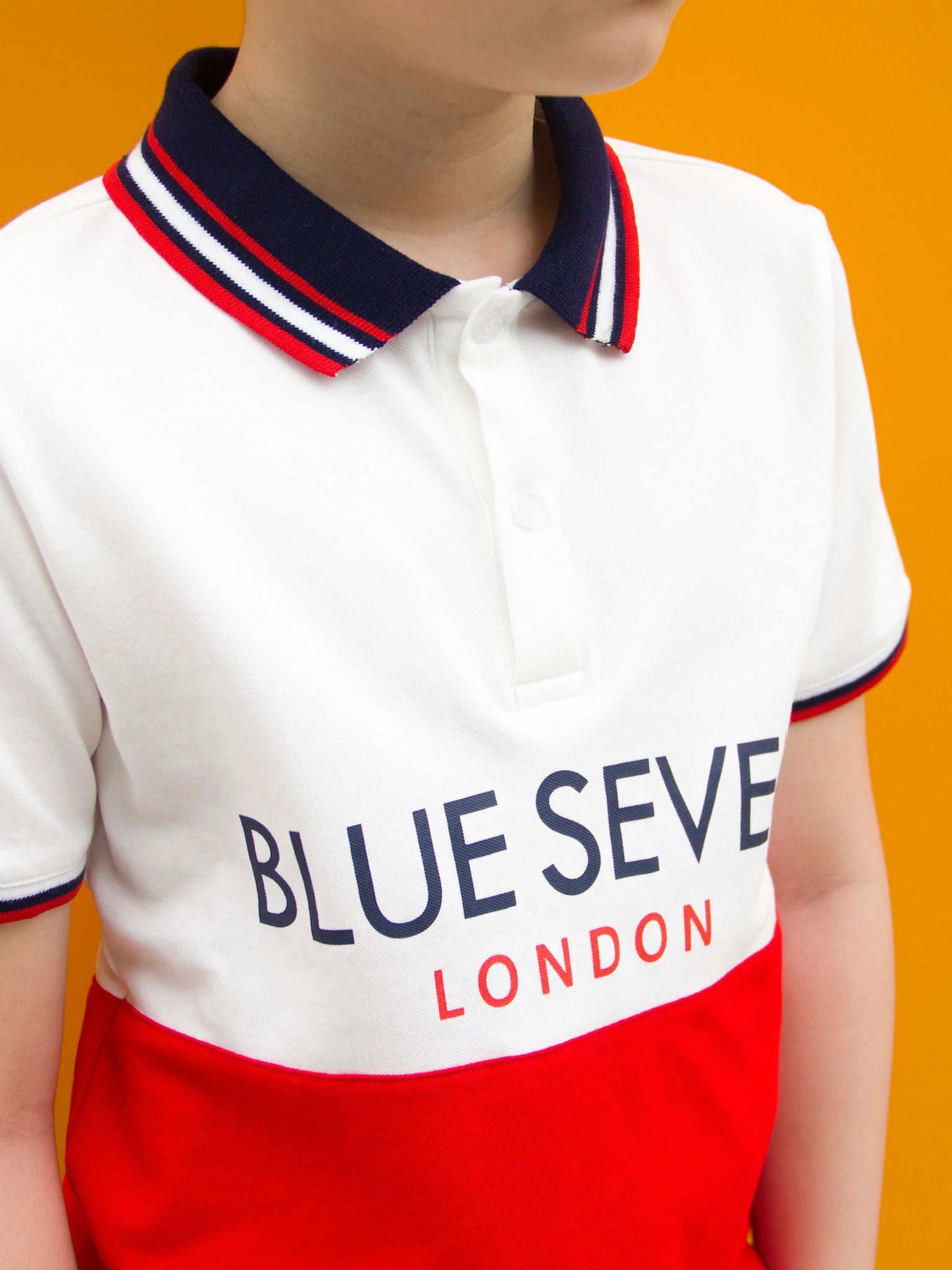 Áo polo bé trai trắng phối đỏ in chữ - Blue Seven