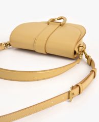 CHARLES & KEITH - Túi đeo vai nữ Metallic Buckle Saddle