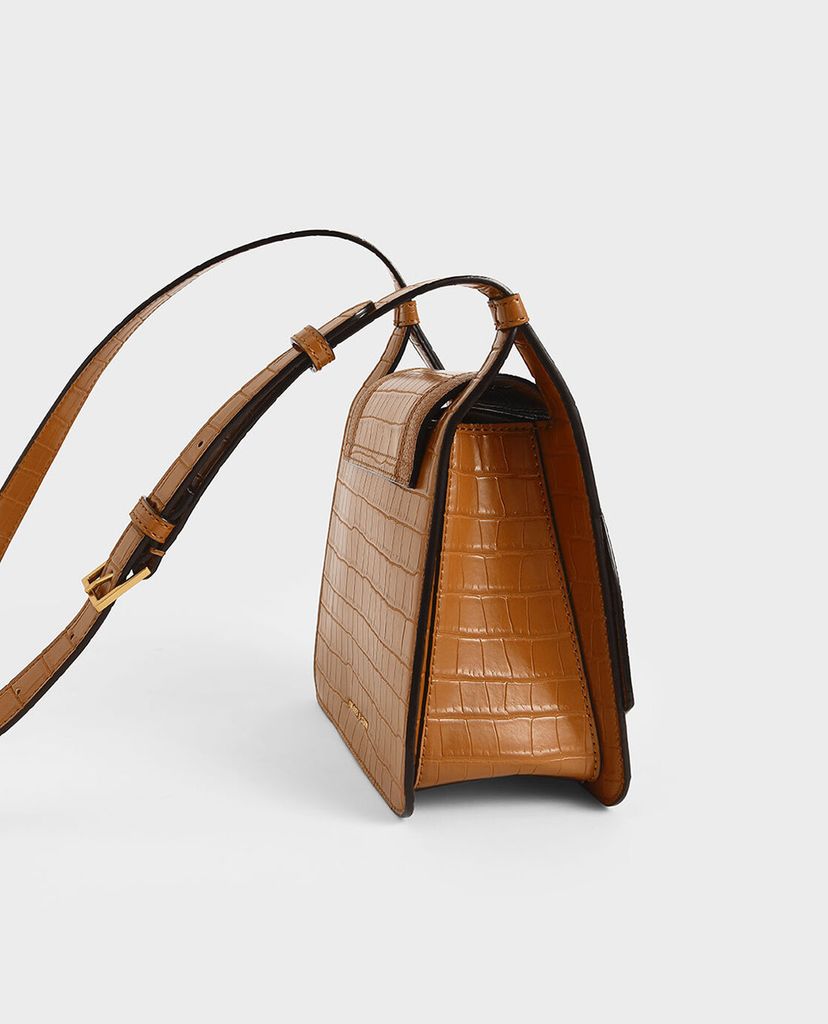 CHARLES & KEITH - Túi đeo chéo nữ hình thang Croc Effect