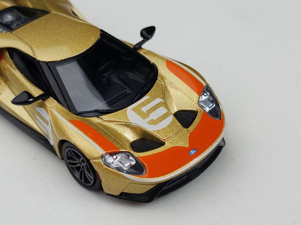 Xe Mô Hình Ford GT Holman Moody Heritage Edition LHD 1:64 MiNiGT ( Vàng Đồng )