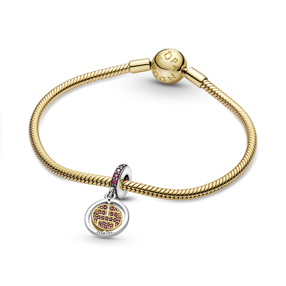 Lucky sterling silver and 14k gold-plated spinning dangle with red CZ