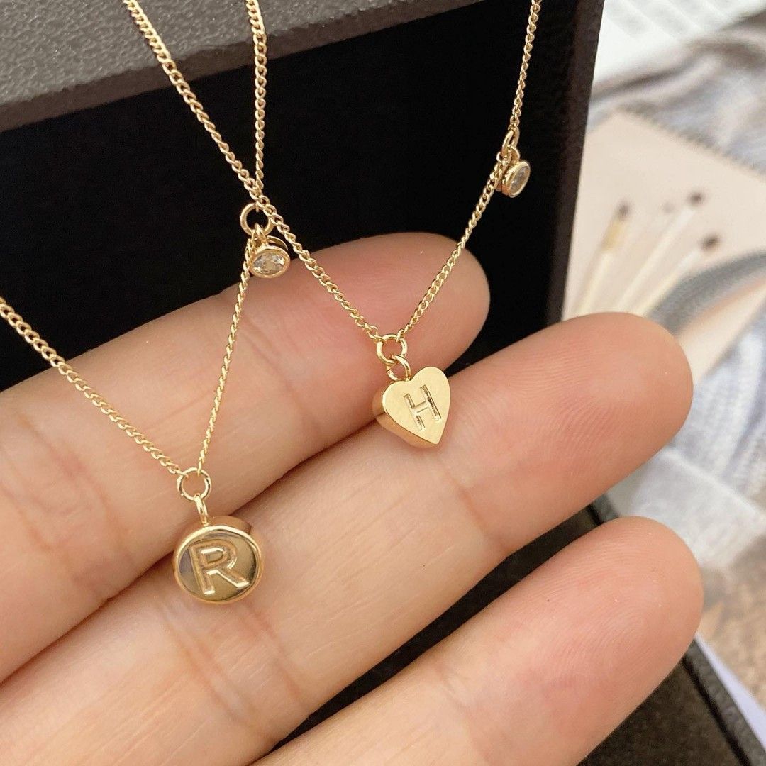 Dây chuyền khắc tên khoen lật vàng 18k mặt trái tim đính đá cao cấp Gix Jewelry