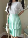 Chân váy xanh xếp ly tầng