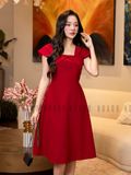 Đầm gấm đỏ tay con