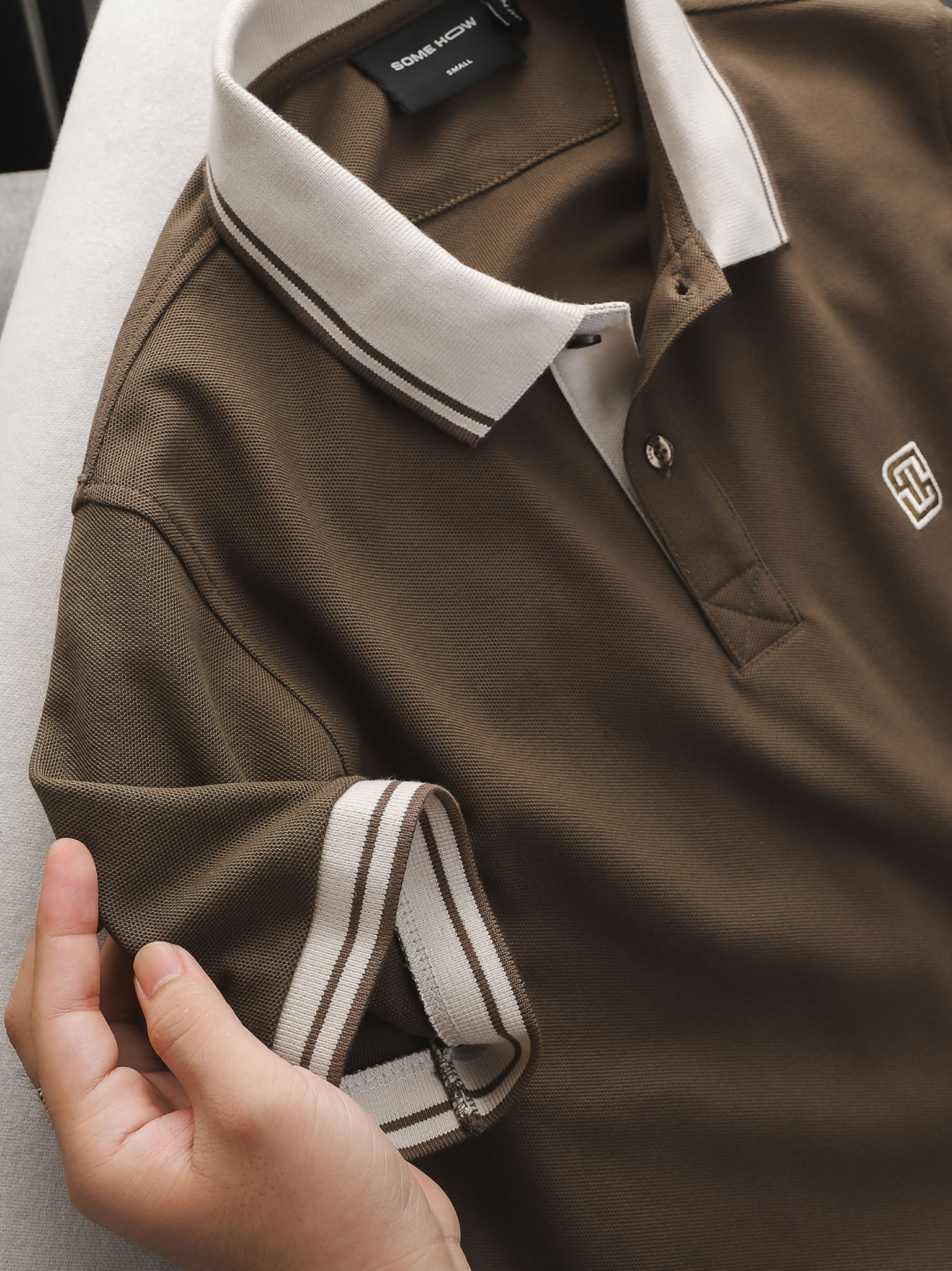 white and brown polo