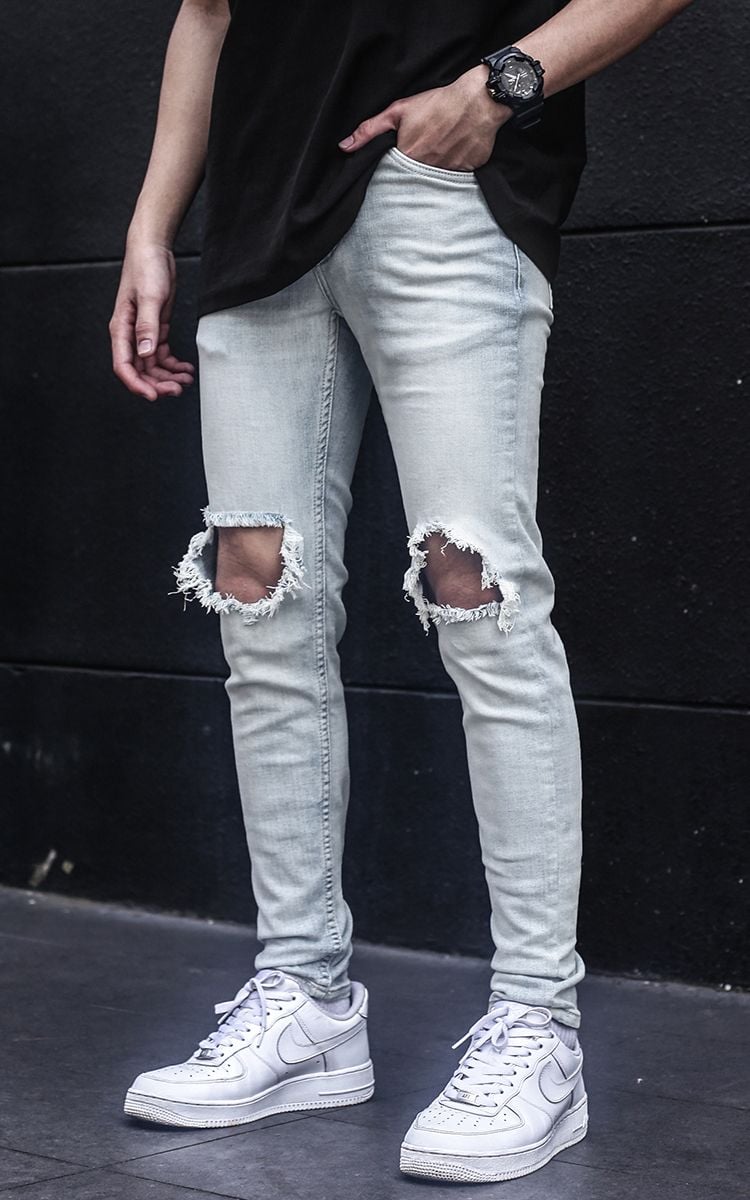 Distressed Skinny Jeans In Mid Wash Blue