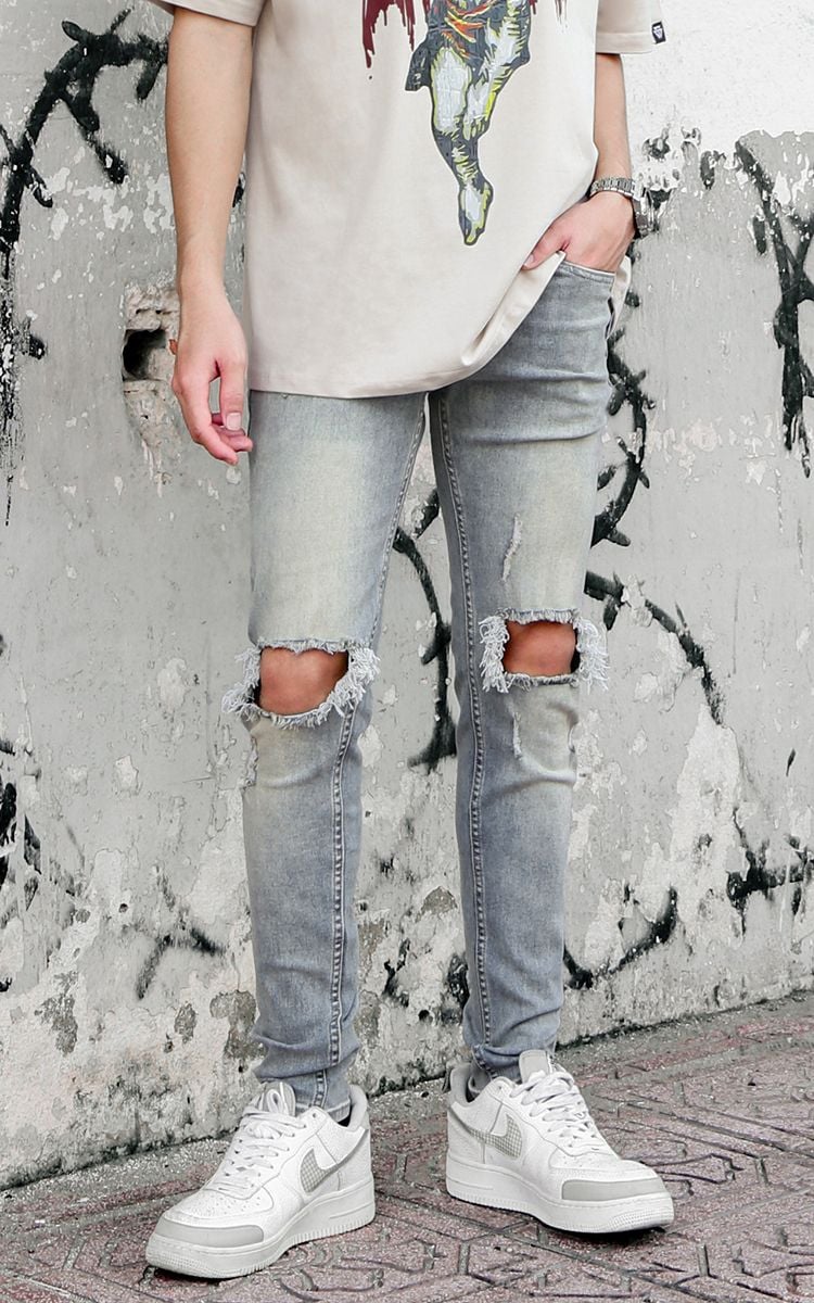 Skinny Jeans With Knee Rips In Mid Wash Blue