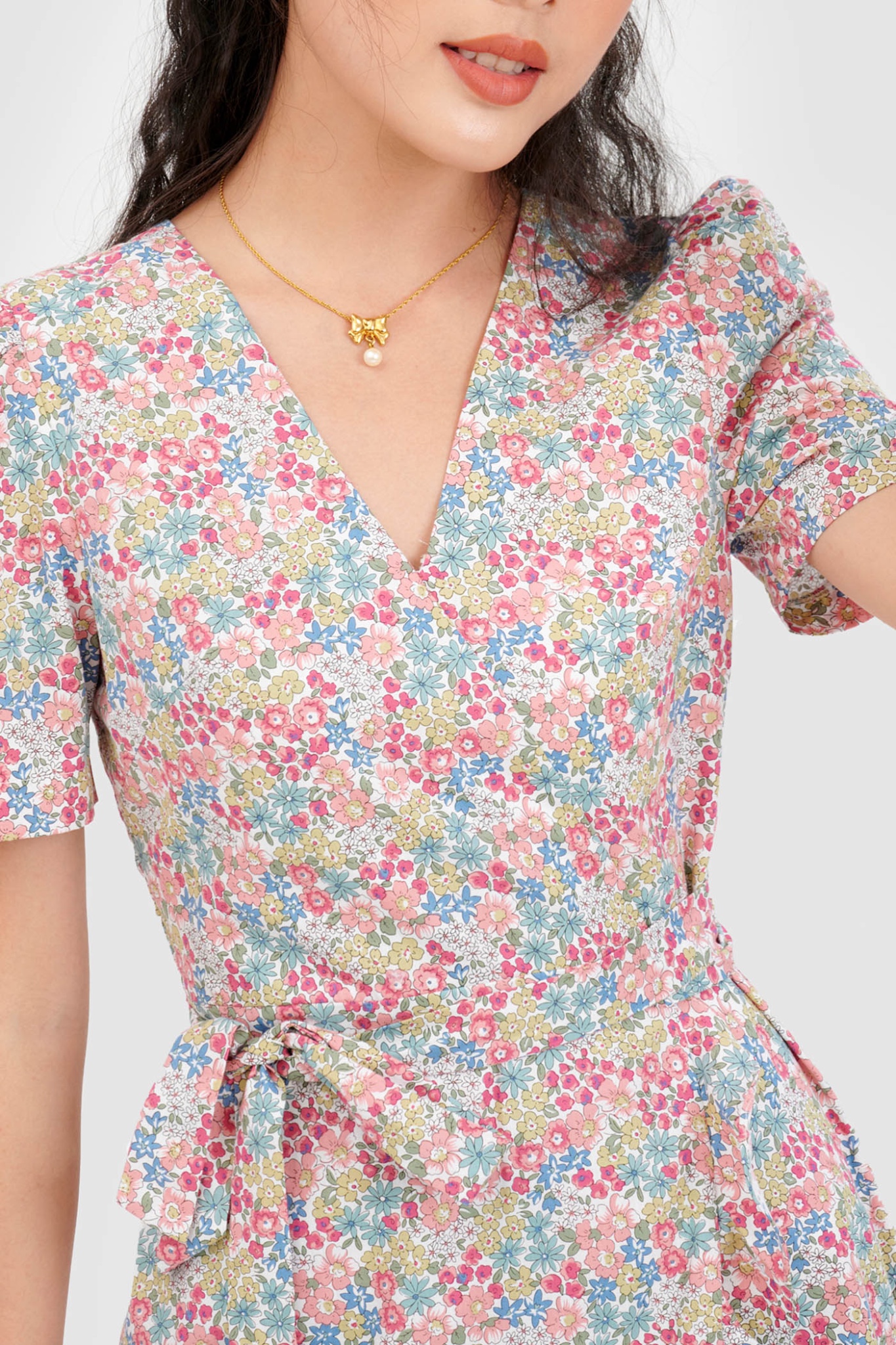 Đầm đắp chéo mini cột nơ hoạ tiết hoa
