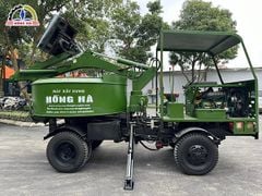 Xe trộn bê tông tự cấp liệu 12 bao 2 cầu Hồng Hà