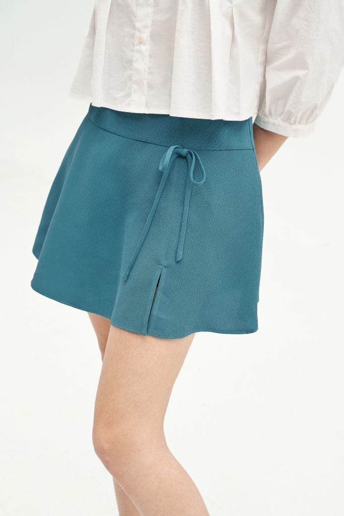 Chân váy mini xoè poly xốp xanh đính nơ