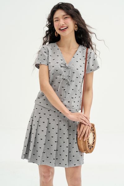 Chân váy mini xoè tech mỏng tàn sáng in nơ