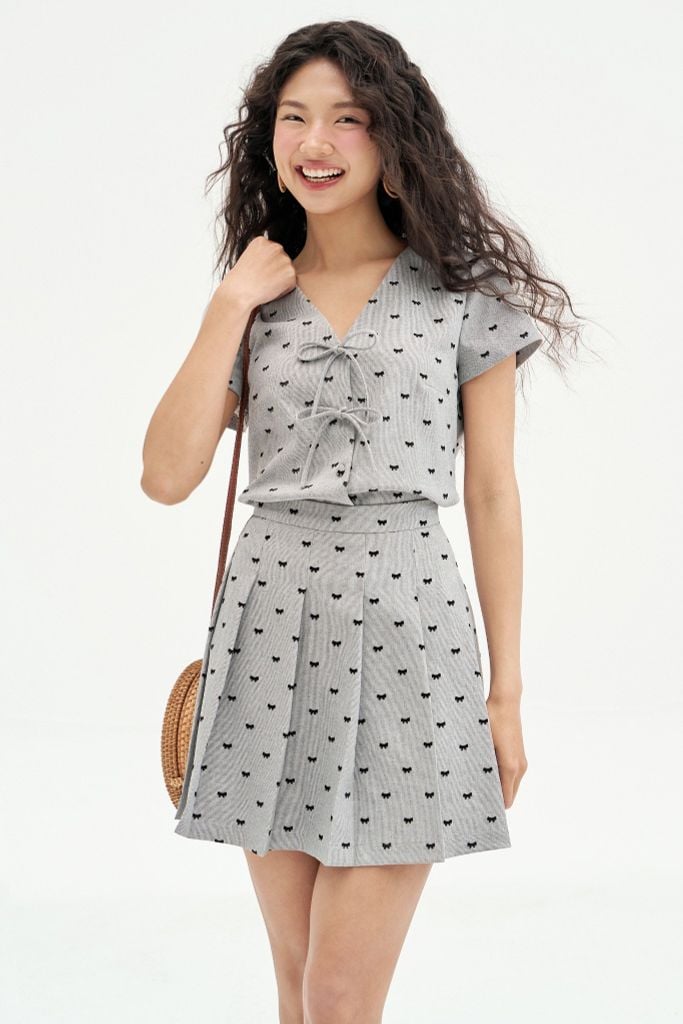Chân váy mini xoè tech mỏng tàn sáng in nơ