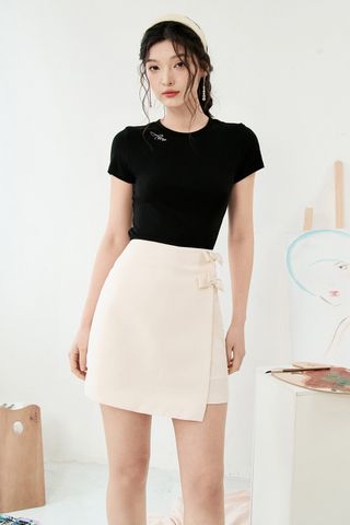 Chân váy mini A trắng kem đính nơ