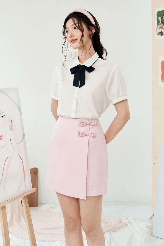 Chân váy mini A tech hồng kem đính nơ