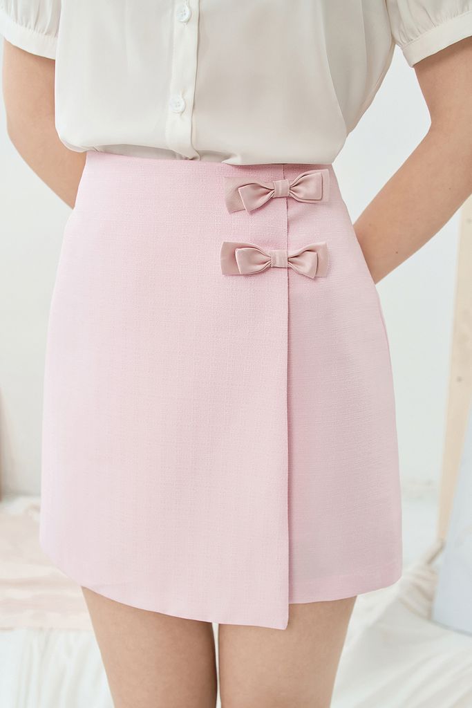 Chân váy mini A tech hồng kem đính nơ