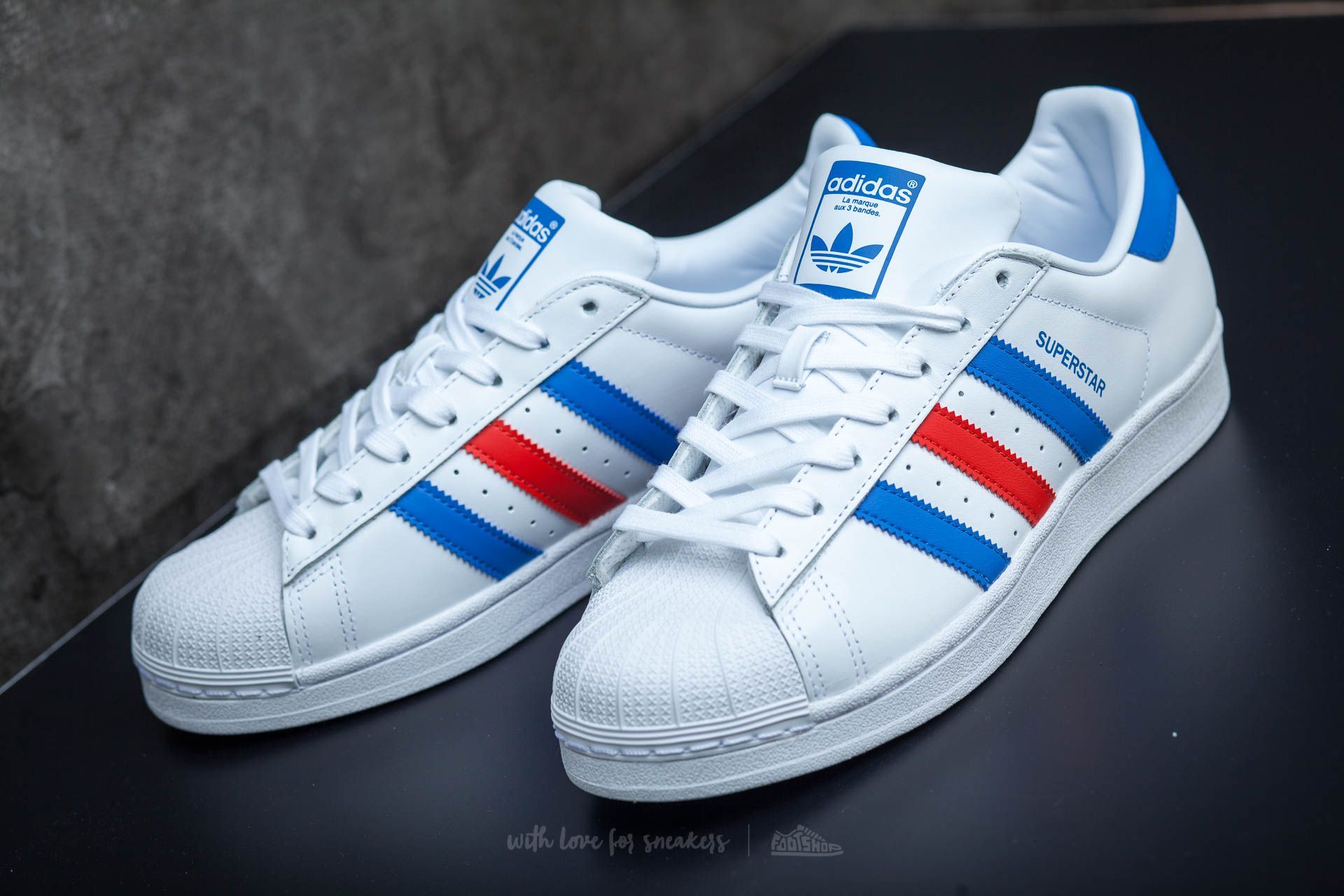 red white and blue adidas superstars