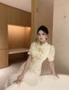 Đầm Kem Nơ Nút Vàng To