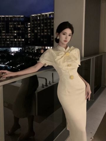 Đầm Kem Nơ Nút Vàng To