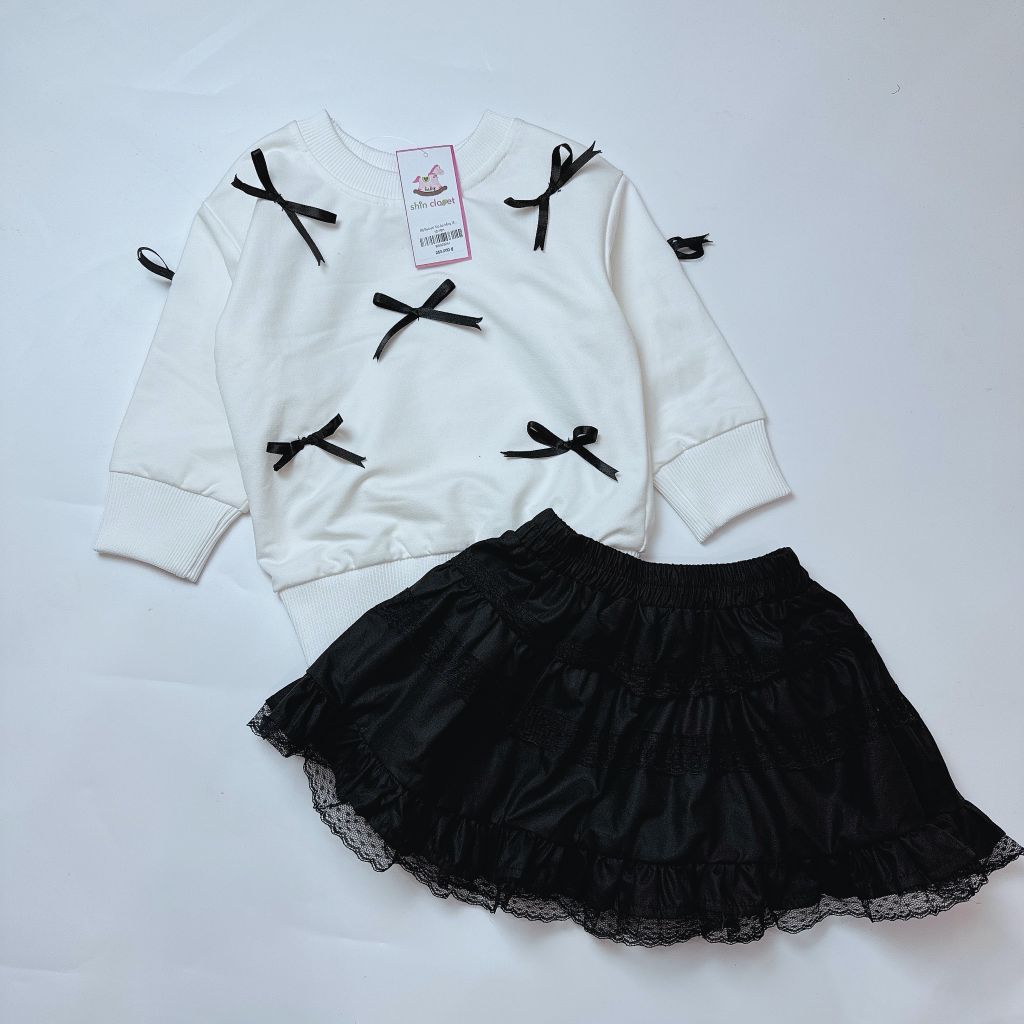 Bộ Babies' Mo áo trắng đính nơ đen + chân váy đen bé gái size 1-10y