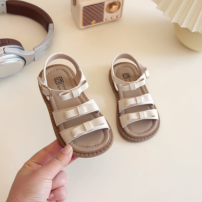 V7921 - Sandal quai ngang đính nơ 2 màu đen/kem bé gái size 21-30