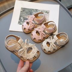 2105 - Sandal đính nơ viền hoa đục lỗ 2 màu hồng/kem bé gái size 21-30