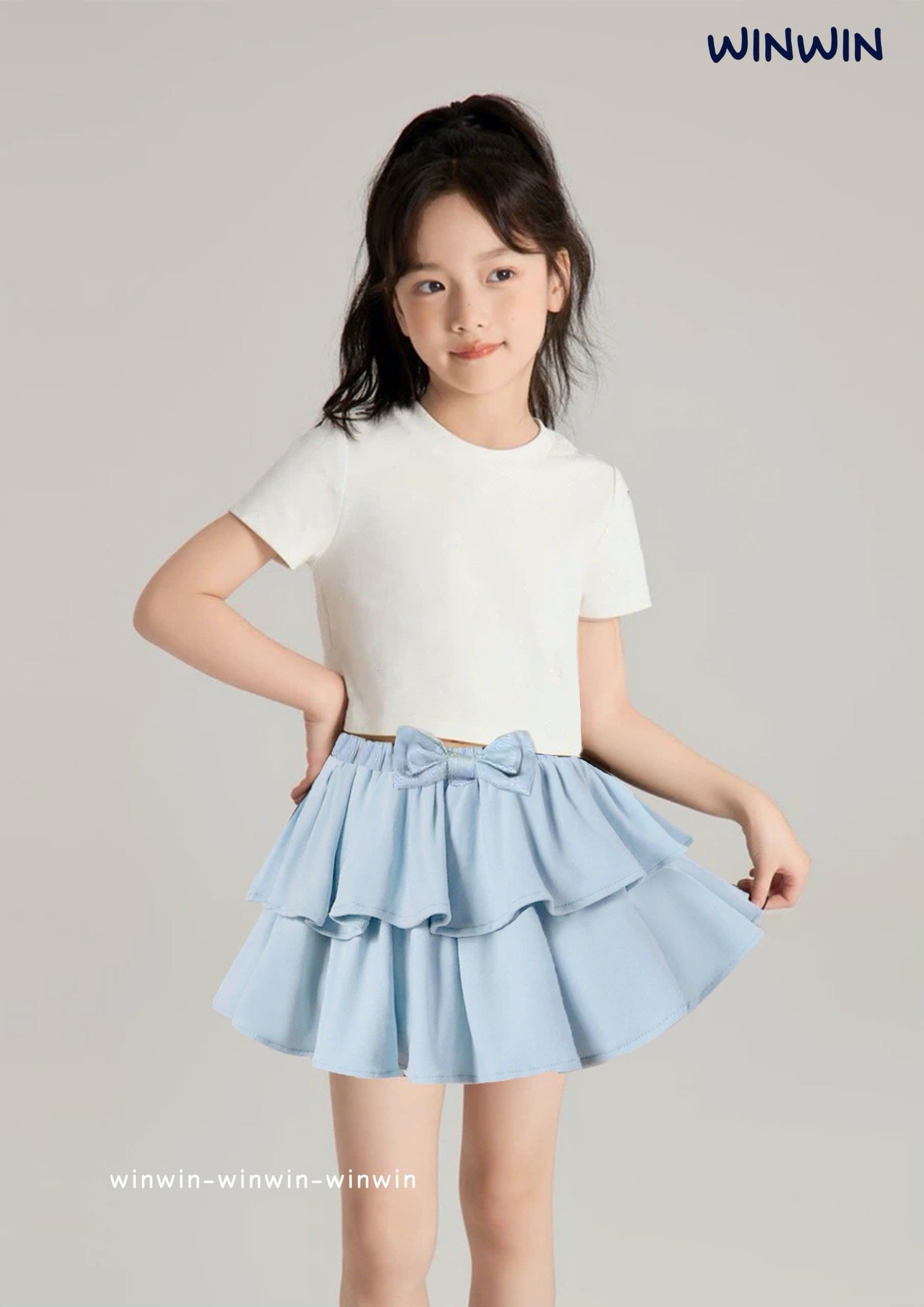 Chân váy thô liền quần Win Win nhún 2 tầng cạp đính nơ size 3 - 14y