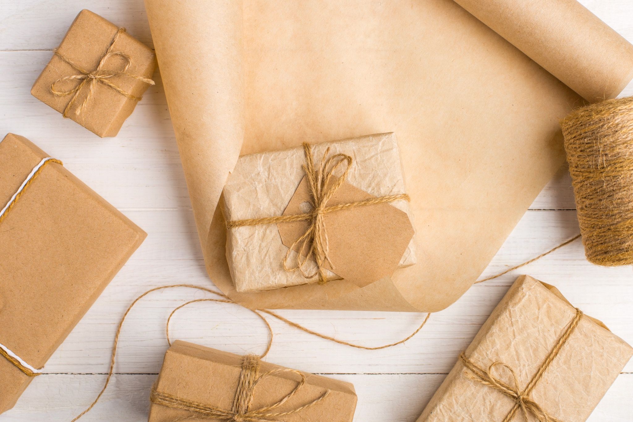 gifts-from-kraft-paper-white-table-with-threads-roll_582c3a2454264ef184fb0fd1a967b521_master.jpg