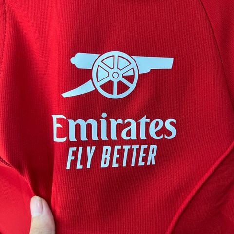 ÁO KHOÁC GIÓ ARSENAL ĐỎ TRƠN LOGO PHÁO TRẮNG 2023/24