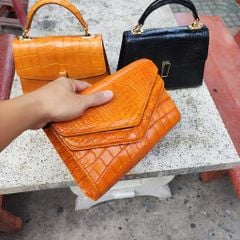 Cầm tay nữ có dây đeo đeo vai tiện lợi. Da bụng cá sấu màu Cam!