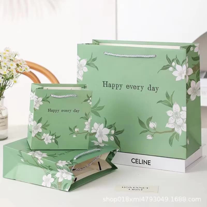  [GIAO HÀNG 7-25 NGÀY] COMBO 100 Túi giấy quai xách họa tiết hoa lá màu hồng,xanh pastel đính kèm ruy băng nơ Q1888 