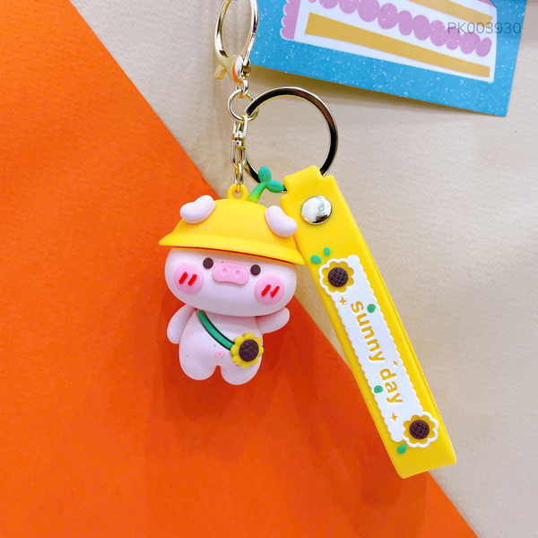 ** Móc khóa heo vàng đeo cặp hướng dương