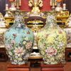  Đôi bảo bình trăm hoa đua nở men sứ vàng  và xanh kích thước cao 70cm đắp nổi vẽ vàng 