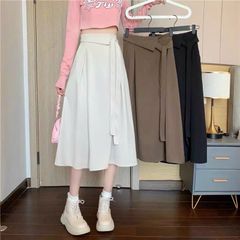 CHÂN VÁY XẾP LY A DÁNG DÀI CỘT NƠ LỆCH