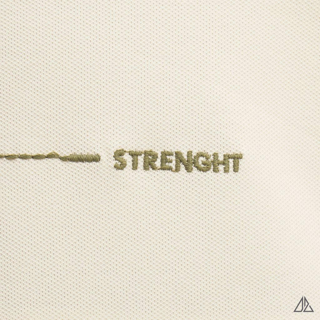 Áo polo đắp ngực kem đen thêu chữ STRENGHT