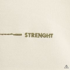 Áo polo đắp ngực kem đen thêu chữ STRENGHT