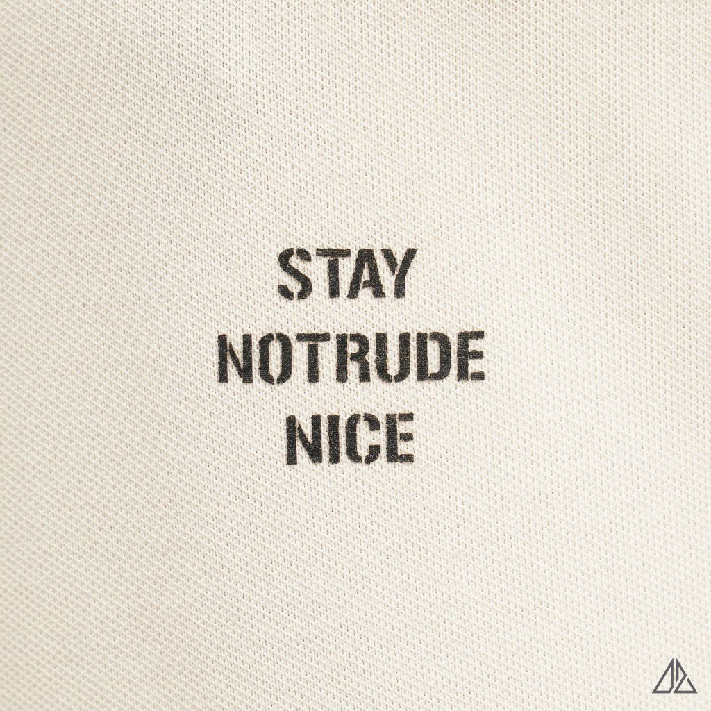 Áo polo phối ngực kem in chữ STAY NOTRUDE NICE