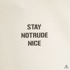 Áo polo phối ngực kem in chữ STAY NOTRUDE NICE