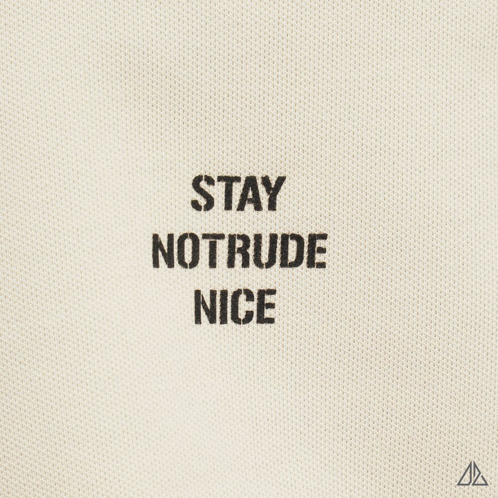 Áo polo phối ngực kem in chữ STAY NOTRUDE NICE
