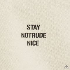 Áo polo phối ngực kem in chữ STAY NOTRUDE NICE