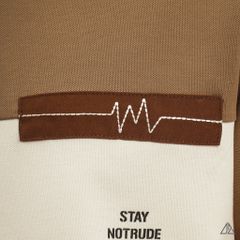 Áo polo phối ngực kem in chữ STAY NOTRUDE NICE