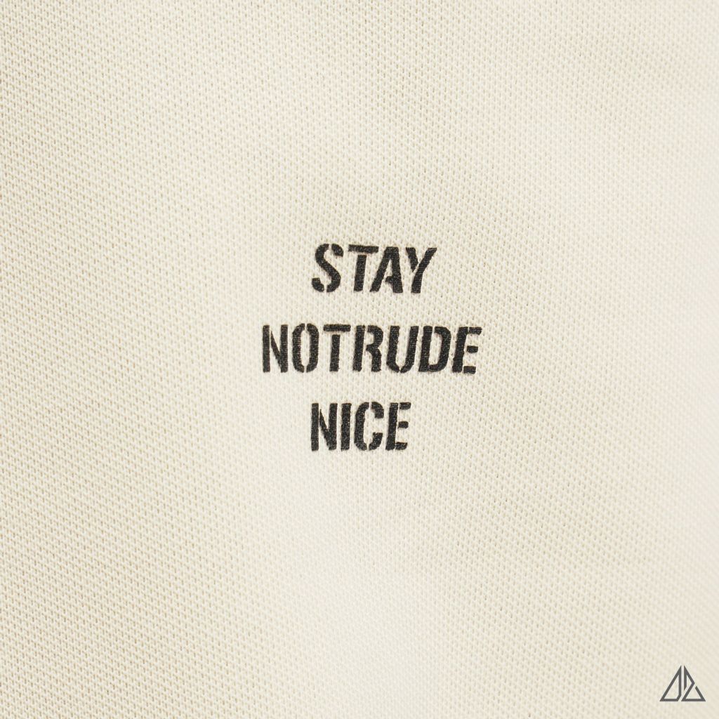 Áo polo phối ngực kem in chữ STAY NOTRUDE NICE