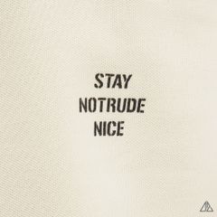 Áo polo phối ngực kem in chữ STAY NOTRUDE NICE