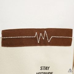 Áo polo phối ngực kem in chữ STAY NOTRUDE NICE