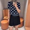  Chân váy xếp ly đen, viền gấu trắng 