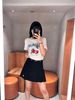  Chân váy ngắn xếp ly đen, gấu trắng, cạp chữ chạy 