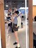 Áo CDG trắng kẻ sọc dọc, họa tiết gấu xanh 
