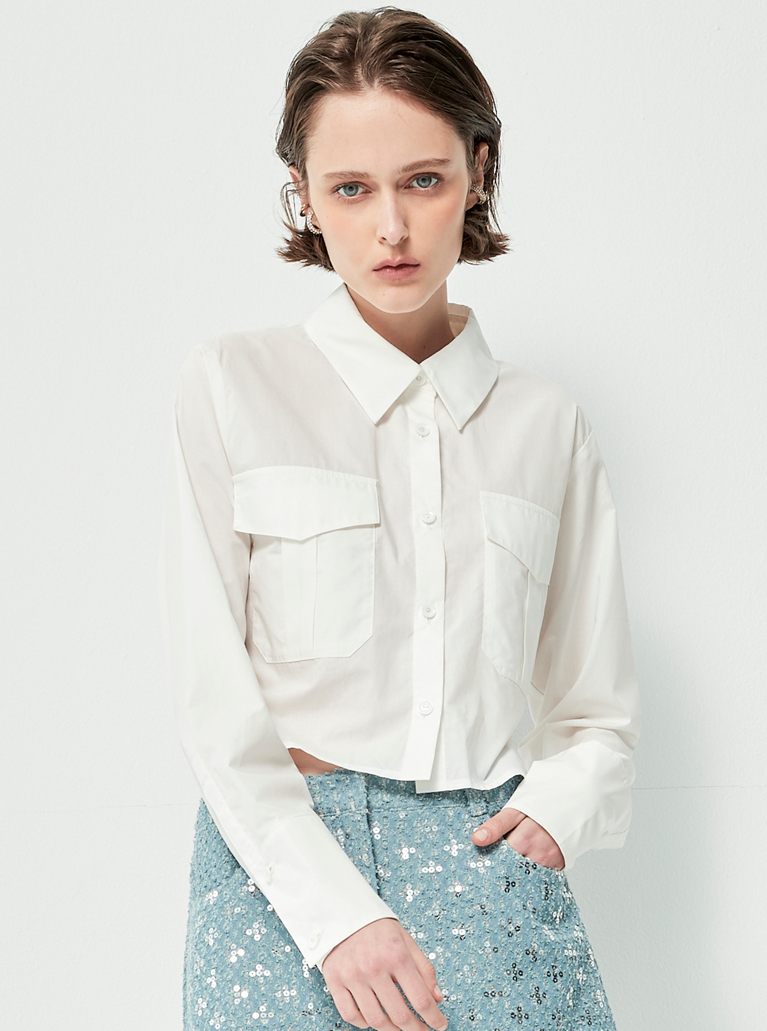 Áo sơ mi mang phong cách tối giản và hiện đại, với phom dáng croptop nhẹ